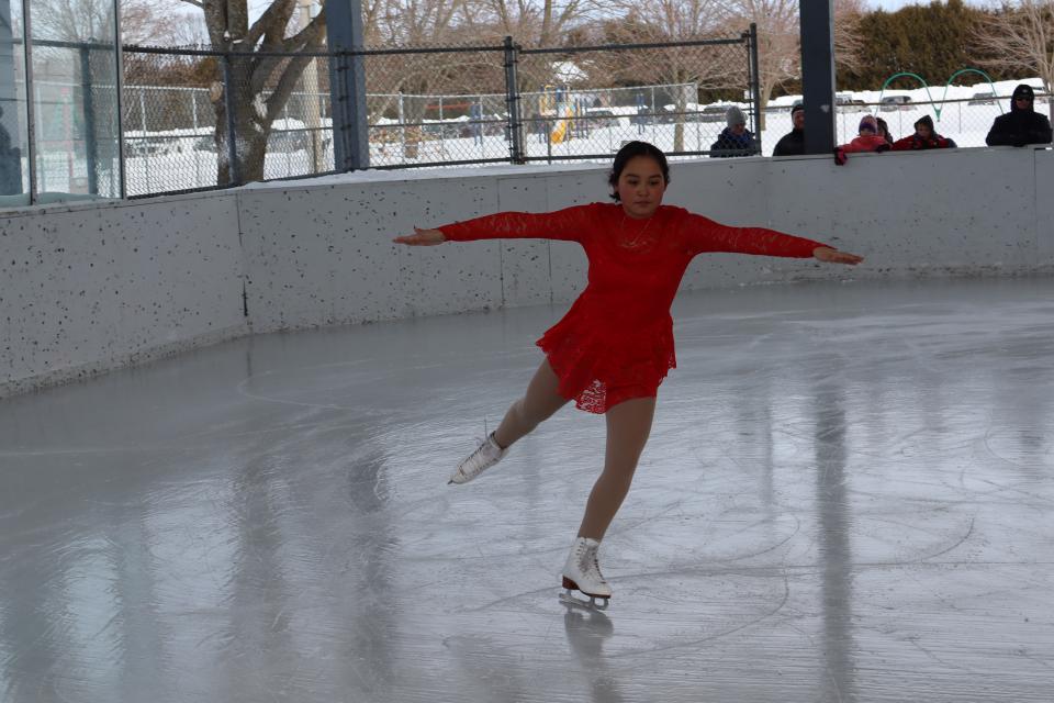 elmvale skater in a red dress performing