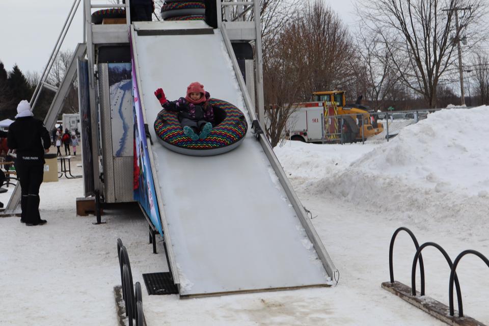 child going down the mobile snow tube hill