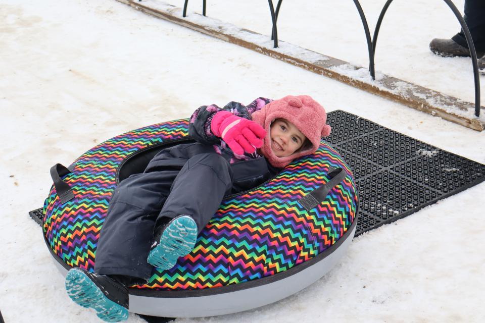 child in a snow tube