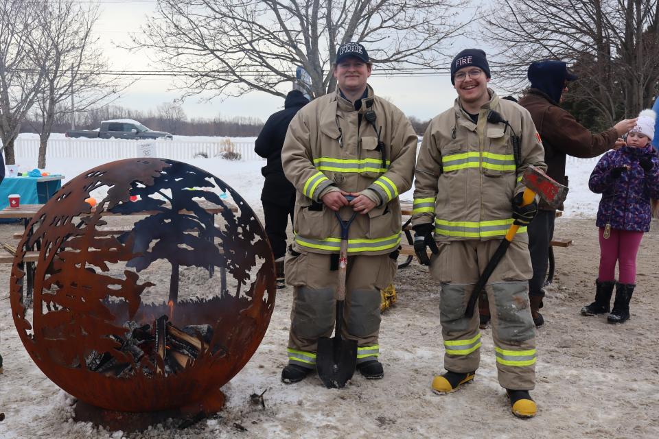 Firefighters maintaining the fire pits at the winter carnaval