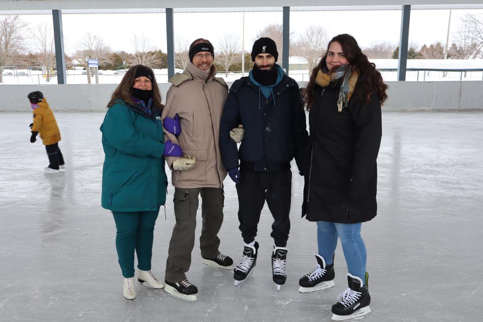 four adults on the skating rink