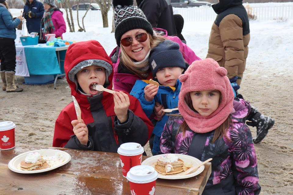 mom and three kids enjoying their pancake lunch