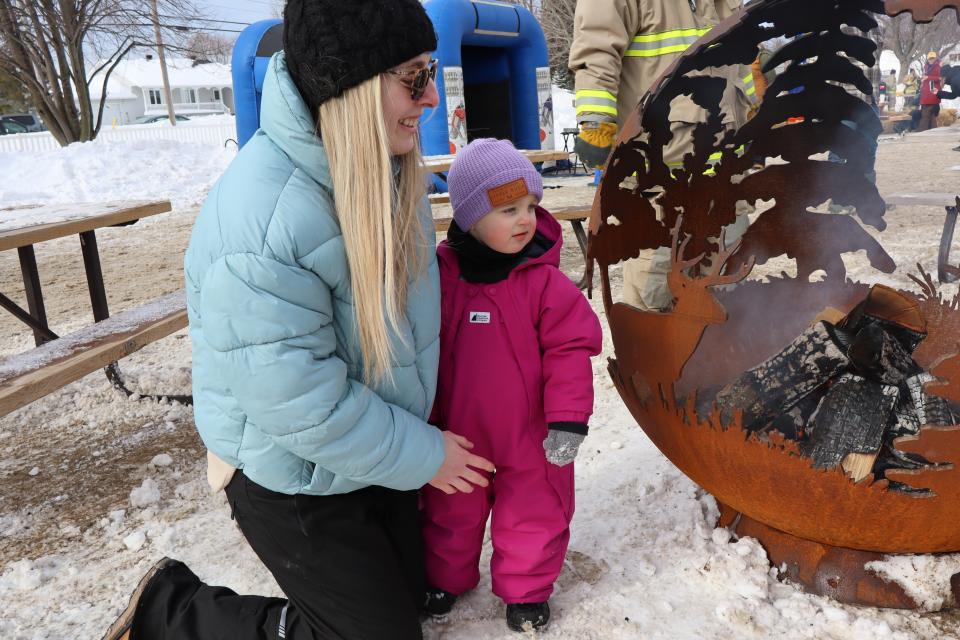 Mom and daughter enjoying the fire