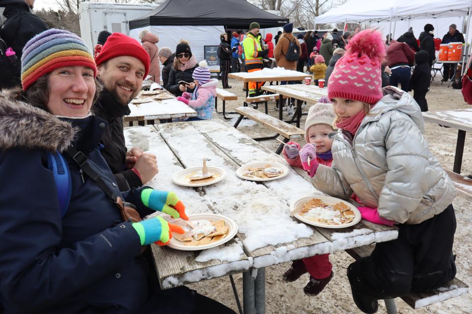 Family with two young girls enjoying a free pancake lunch