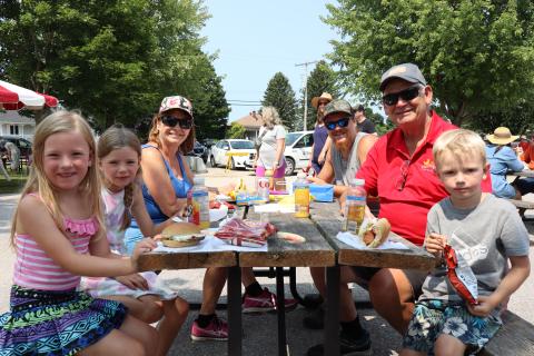 Three generations of a family enjoying lunch at the BBQ