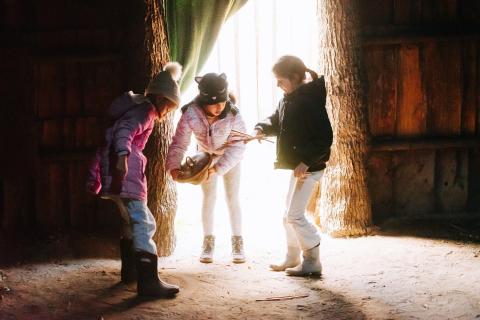 three young children participating in the adventures in time travel event with older tools