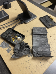 burnt device and charger on a table